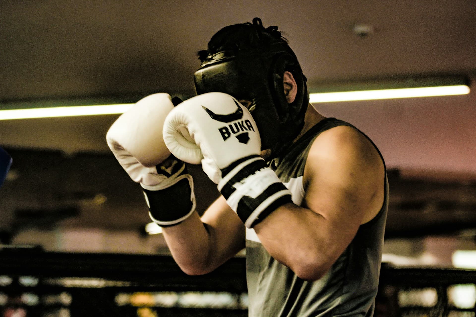 Boxer in headgear and gloves ready to train